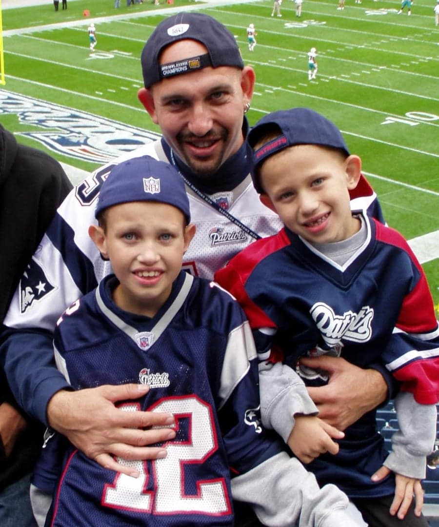 The brothers as kids with their dad at a Patriots game