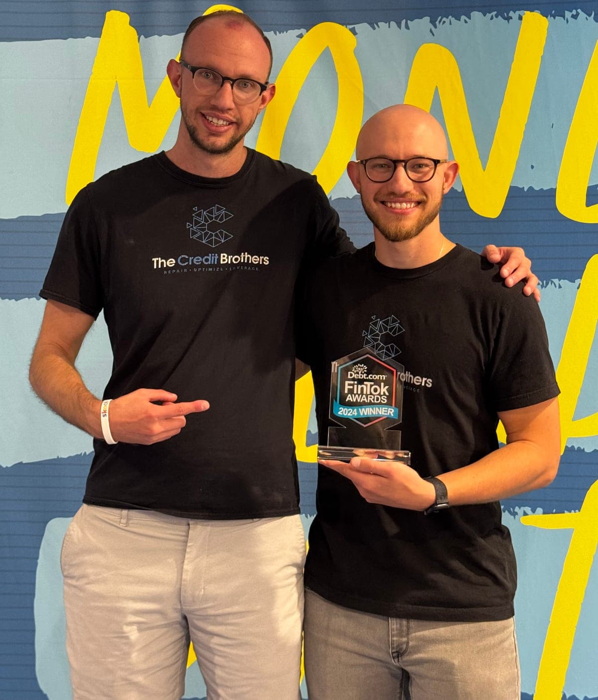 The Credit Brothers holding the Debt.com FinTok Awards 2024 trophy